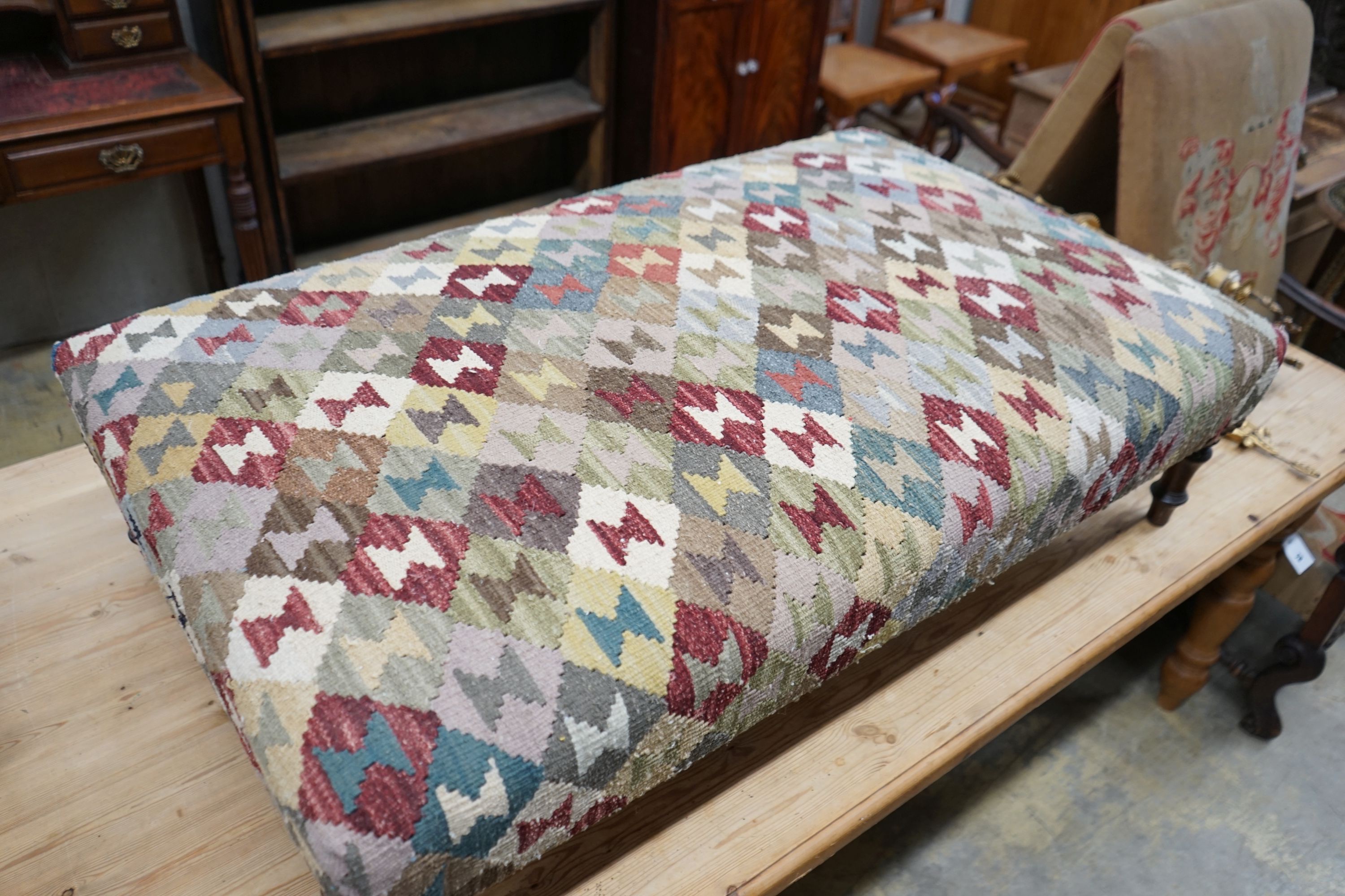 A rectangular polychrome Kelim footstool, length 115cm, depth 70cm, height 33cm